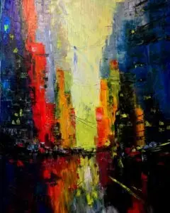 A bold and colorful abstract cityscape painting created with thick, textured brushstrokes. Towering buildings in hues of red, yellow, orange, and blue rise on both sides of a narrow path, which is reflected below as if on a wet street or river. The center glows with light, creating a sense of depth and movement. The piece has an impressionistic, almost dreamlike atmosphere, evoking the feeling of a city at twilight or dawn.