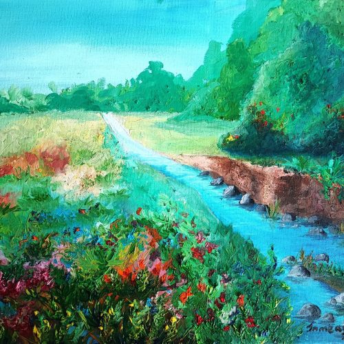 A bright, tranquil landscape showing a grassy path stretching into the distance beneath a blue sky. A stream runs alongside the path, bordered by vibrant wildflowers and dense green foliage. The right bank is slightly eroded, revealing earthy tones, while the left side bursts with reds, pinks, and purples from blooming flowers. The background features rolling green trees and bushes. The painting is signed 'in me art 2023' in the bottom right corner